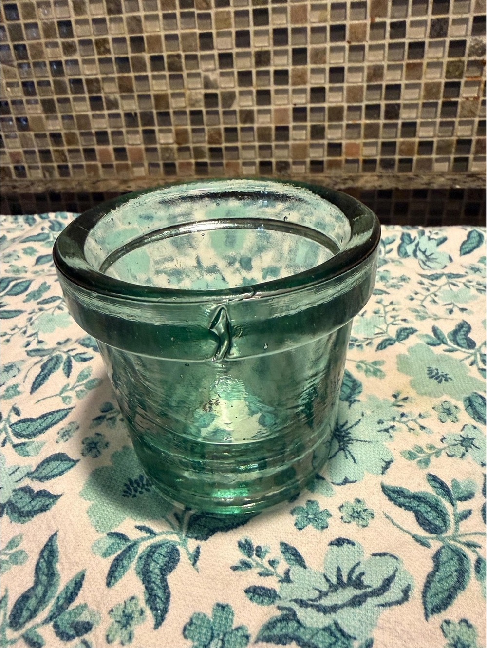 This is a vintage heavy aqua glass utilitarian vessel with bubble inclusions.
